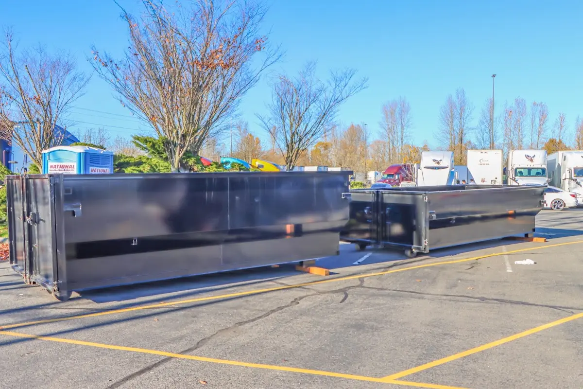 Professional dumpster rental service with roll-off container on residential driveway in Elmwood